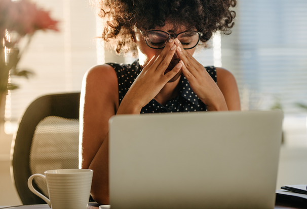 Middle Class Woman Looking At Laptop Looking Stressed